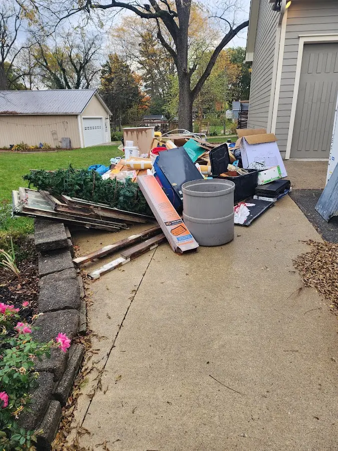 Dumpster being loaded with debris for Estate Cleanout Dumpster Rental in Eastampton